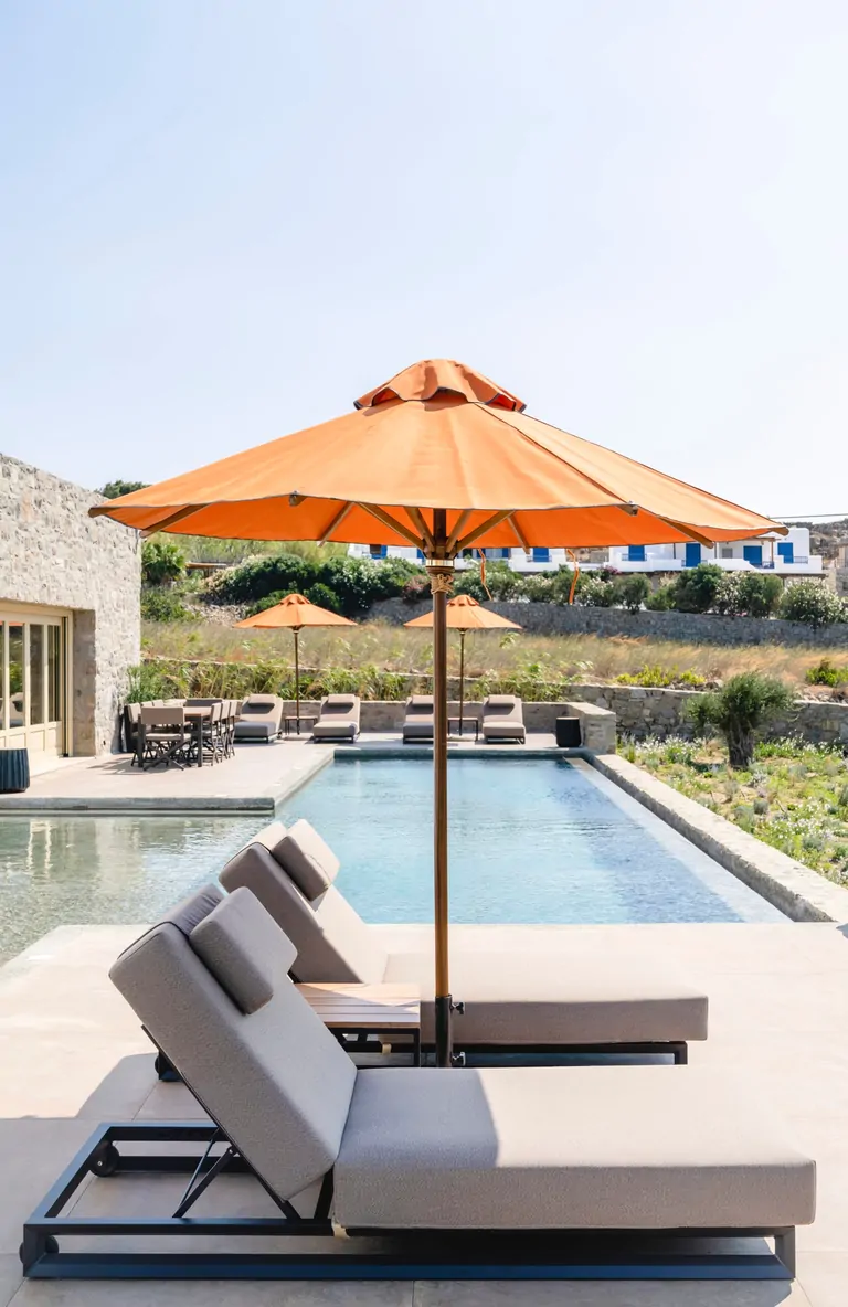 Poolside sun loungers at a Mykonos villa