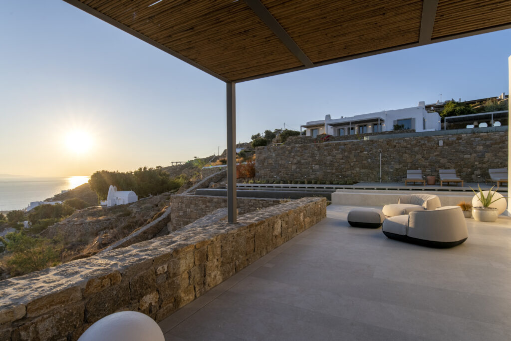 Villa terrace at sunset above the Aegean in Mykonos