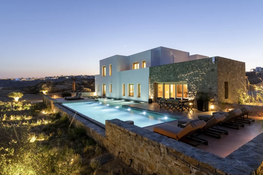 Villa and pool lit at dusk on Mykonos